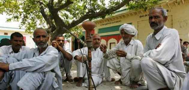 Villagers sit after attending a panchayat, or village council meeting in Haryana.