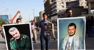 Iraqi demonstrators hold up pictures of prominent Shiite leaders from Yemen and Iran in March 2015.